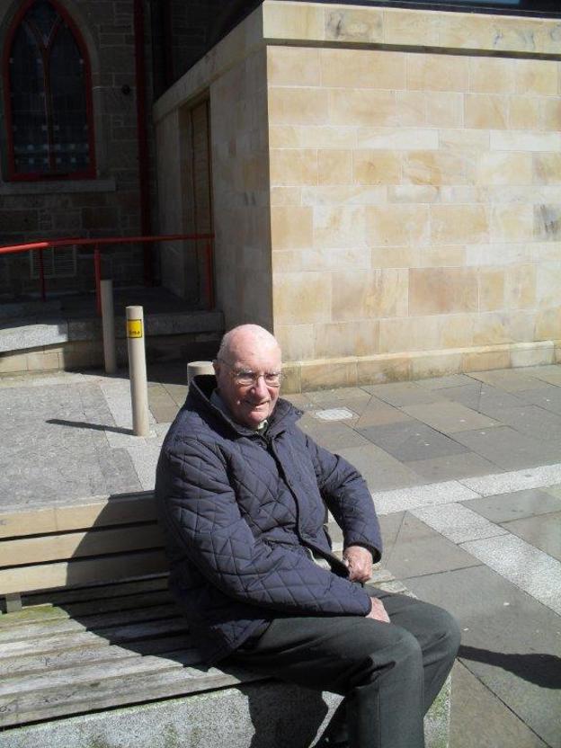Robert enjoying the sunshine as we wait for our bus.jpg